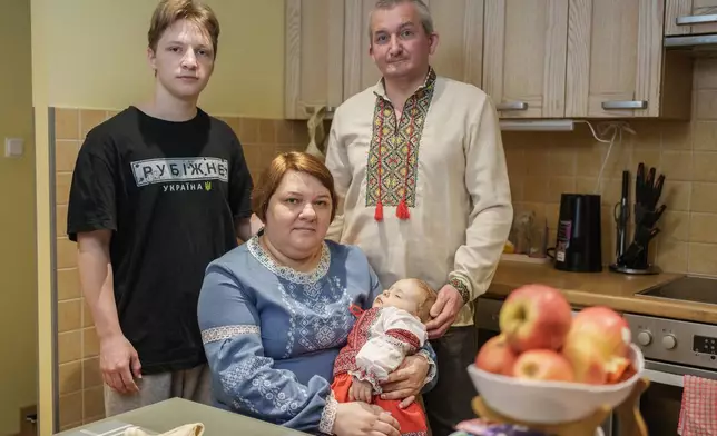 Oleksii Vnukov, right, his wife, Inna Vnukova, center left, and their children Evhen, left, and Alisa, pose during an interview with The Associated Press in their apartment in Tallinn, Estonia, Tuesday, Feb. 17, 2026. (AP Photo)