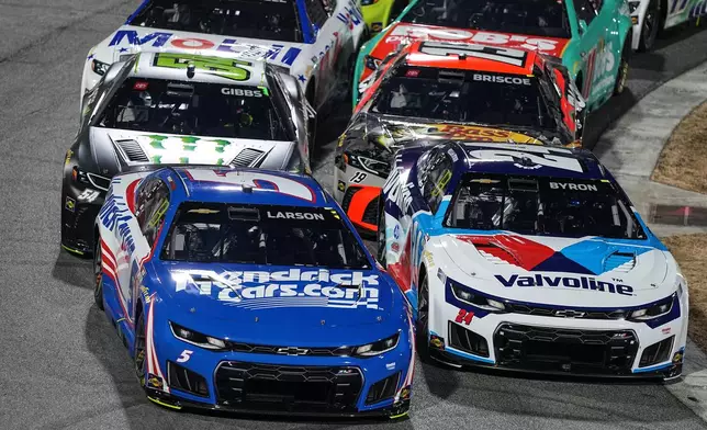 Kyle Larson (5) leads a pack of cars into Turn 2 during NASCAR's The Clash preseason auto race at Bowman Gray Stadium, Wednesday, Feb. 4, 2026, in Winston-Salem, N.C. (AP Photo/Matt Kelley)