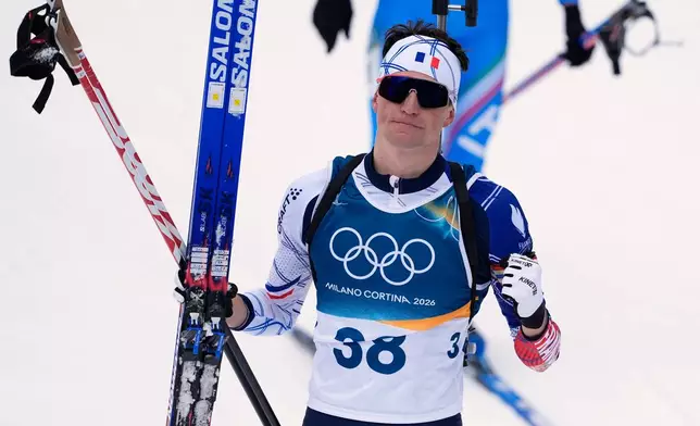 Eric Perrot, of France, reacts after finishing the men's 20-kilometer individual biathlon race at the 2026 Winter Olympics in Anterselva, Italy, Tuesday, Feb. 10, 2026. (AP Photo/Andrew Medichini)
