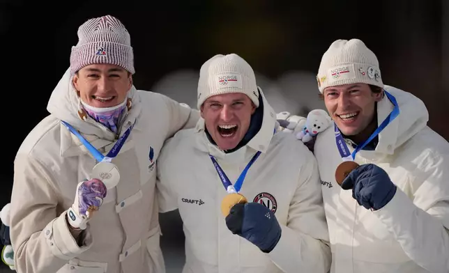 Silver medalist Eric Perrot, of France, from left, gold medalist Johan-Olav Botn, of Norway, and bronze medalist Sturla Holm Laegreid, of Norway, pose after the men's 20-kilometer individual biathlon race at the 2026 Winter Olympics in Anterselva, Italy, Tuesday, Feb. 10, 2026. (AP Photo/Mosa'ab Elshamy)