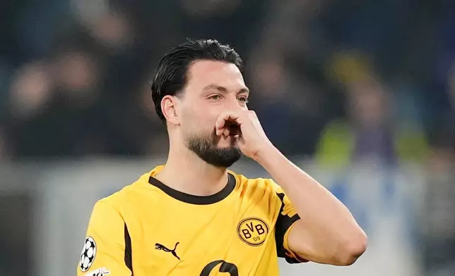 Dortmund's Ramy Bensebaini reacts during the Champions League second leg playoff match between Atalanta and Borussia Dortmund in Bergamo, Italy, Wednesday, Feb. 25, 2026. (Spada/LaPresse via AP)