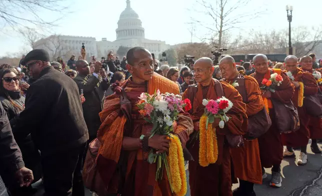 Buddhist monks walk near the U.S. Capitol, on Capitol Hill, during the Walk For Peace, Wednesday, Feb. 11, 2026, in Washington. (AP Photo/Rahmat Gul)