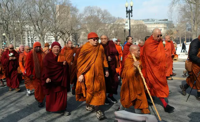Buddhist monks walk near the U.S. Capitol, on Capitol Hill, during the Walk For Peace, Wednesday, Feb. 11, 2026, in Washington. (AP Photo/Rahmat Gul)