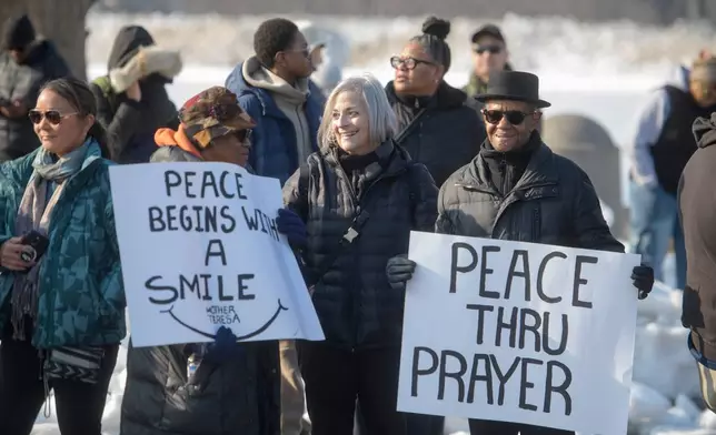 People wait for the arrival of the Buddhist monks near the Peace Monument on Capitol Hill, during the Walk for Peace, in Washington, Wednesday, Feb., 11, 2026. (AP Photo/Rod Lamkey, Jr.)