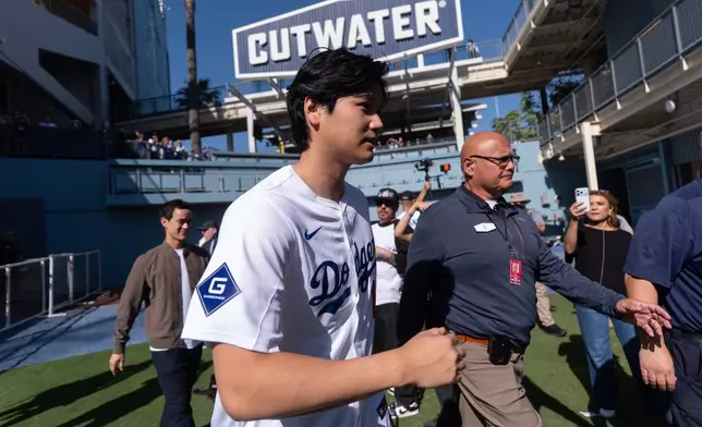 Los Angeles Dodgers two-way player Shohei Ohtani arrives to talk to reporters during DodgerFest at Dodger Stadium in Los Angeles, Saturday, Jan. 31, 2026. (AP Photo/Jae C. Hong)