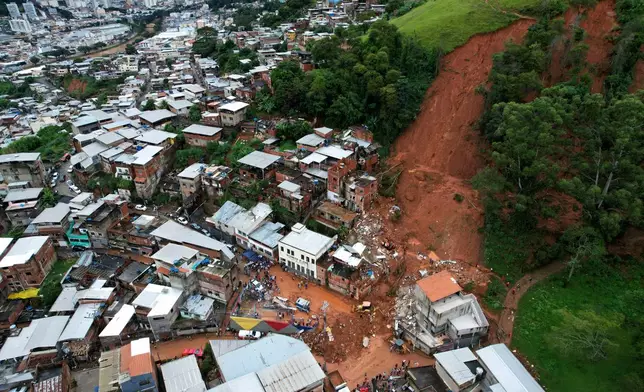 Collapsed homes sit after heavy rains and severe flooding in the Parque Burnier neighborhood of Juiz de Fora in Minas Gerais state, Brazil, Tuesday, Feb. 24, 2026. (AP Photo/Silvia Izquierdo)