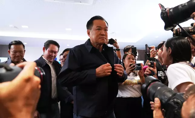 Thailand's Prime Minister and leader of Bhumjaithai Party Anutin Charnvirakul, center, leave after a press conference at the party headquarters following the general election in Bangkok, Sunday, Feb. 8, 2026. (AP Photo/Sakchai Lalit)