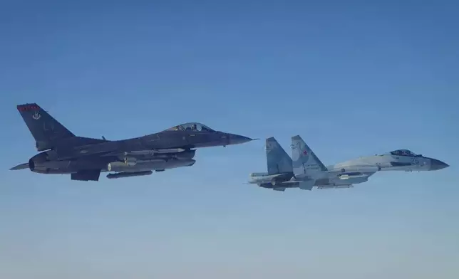 This photo provided by the U.S. Department of Defense shows a North American Aerospace Defense Command F-16 fighter aircraft intercepting a Russian Su-35 military aircraft near the Bering Strait, west of Alaska, on Thursday, Feb. 19, 2026. (Department of Defense photo via AP)