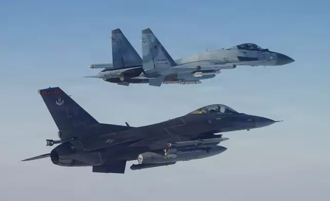 This photo provided by the U.S. Department of Defense shows a North American Aerospace Defense Command F-16 fighter aircraft intercepting a Russian Su-35 military aircraft near the Bering Strait, west of Alaska, on Thursday, Feb. 19, 2026. (Department of Defense photo via AP)