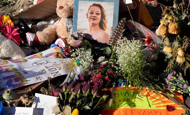 FILE - Flowers and photos are left at a memorial site for Renee Good on Saturday, Jan. 31, 2026, in Minneapolis. (AP Photo/Alex Brandon, File)