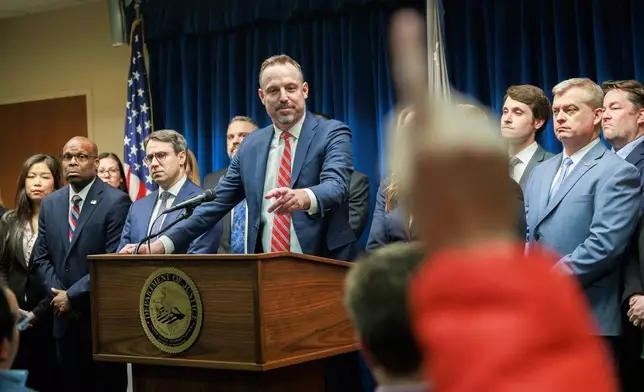 FILE - Assistant U.S. Attorney Joe Thompson, center, answers questions during a news conference at the Minneapolis federal courthouse, Wednesday, March 19, 2025, after a jury found the alleged ringleader of a massive pandemic fraud case guilty on all counts. (Kerem Yücel/Minnesota Public Radio via AP, File)