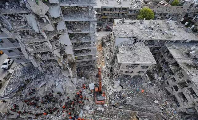 FILE - Israeli soldiers search through the rubble of residential buildings destroyed by an Iranian missile strike in Bat Yam, central Israel, June 15, 2025. (AP Photo/Baz Ratner, File)