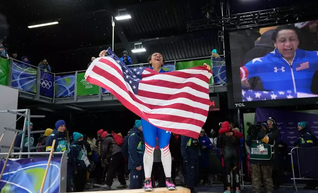 United States' gold medalist Elana Meyers Taylor celebrates at the finish after the women's monobob competition at the 2026 Winter Olympics, in Cortina d'Ampezzo, Italy, Monday, Feb. 16, 2026. (AP Photo/Alessandra Tarantino)