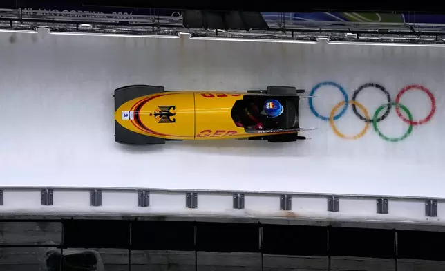 Germany's Lisa Buckwitz slides down the track during a women's monobob run at the 2026 Winter Olympics, in Cortina d'Ampezzo, Italy, Monday, Feb. 16, 2026. (AP Photo/Alessandra Tarantino)