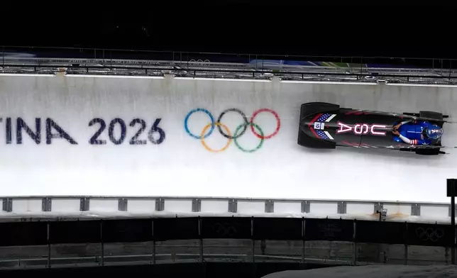 United States' Elana Meyers Taylor slides down the track during a women's monobob run at the 2026 Winter Olympics, in Cortina d'Ampezzo, Italy, Monday, Feb. 16, 2026. (AP Photo/Alessandra Tarantino)