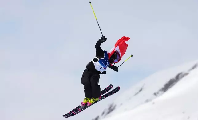 Switzerland's Mathilde Gremaud celebrates her gold medal on her final run in the women's freestyle skiing slopestyle finals at the 2026 Winter Olympics, in Livigno, Italy, Monday, Feb. 9, 2026. (AP Photo/Abbie Parr)