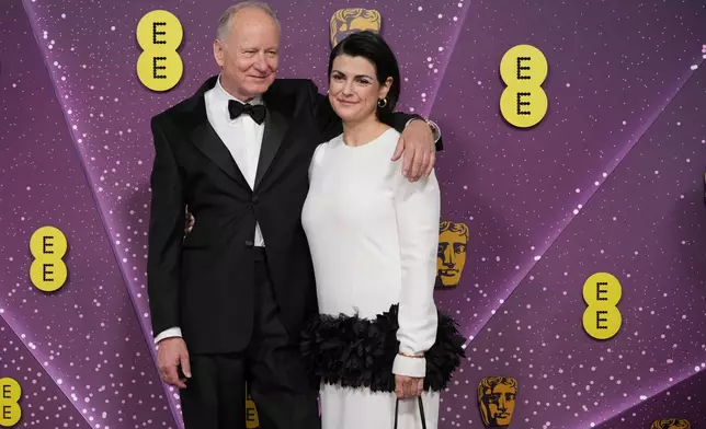 Stellan Skarsgard and Megan Everett-Skarsgard pose for photographers upon arrival at the 79th British Academy Film Awards, BAFTA's, in London, Sunday, Feb. 22, 2026. (AP Photo/Alastair Grant)