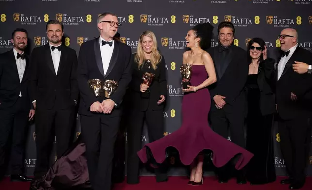 Andy Jurgensen, from left, Leonardo DiCaprio, Teyana Taylor, Paul Thomas Anderson, Sara Murphy, Chase Infiniti, Benicio Del Toro, Cassandra Kulukundis, and Michael Bauman pose with the awards for best director, cinematography, and adapted screenplay for 'One Battle After Another' at the 79th British Academy Film Awards, BAFTA's, in London, Sunday, Feb. 22, 2026. (AP Photo/Alastair Grant)
