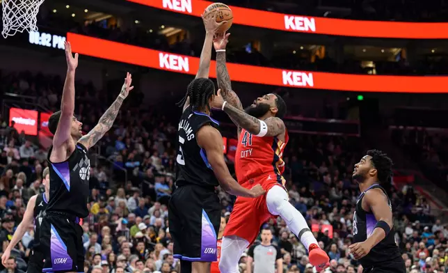 Utah Jazz forward Cody Williams, center left, blocks a shot by New Orleans Pelicans guard Saddiq Bey (41) during the first half of an NBA basketball game, Thursday, Feb. 26, 2026, in Salt Lake City. (AP Photo/Tyler Tate)