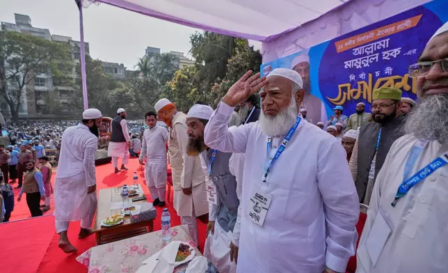 Jamaat-e-Islami leader Shafiqur Rahman, second right in front, greets to the supporters as he arrives to attend the last day of an election rally for Bangladesh Khilafat Majlis candidate Mamunul Haque, organized by the eleven party alliance in Dhaka, Bangladesh, Monday, Feb. 9, 2026. (AP Photo/Anupam Nath)