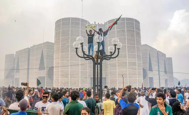 Protesters celebrate outside the Bangladesh Parliament after getting the news of Prime Minister Sheikh Hasina's resignation, in Dhaka, Bangladesh, Aug. 5, 2024. (AP Photo/Abid Hasan, File)