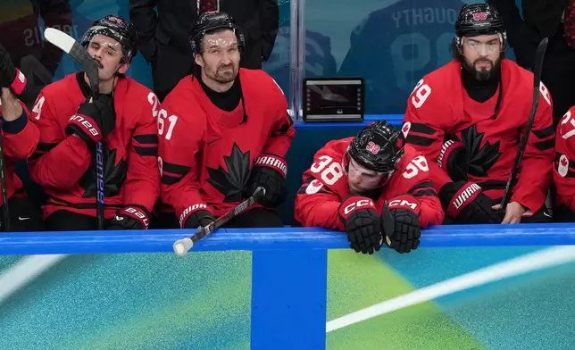 Team Canada players watch as United States players celebrate following the United States' win in the men's ice hockey gold medal game at the 2026 Winter Olympics in Milan, Italy, Sunday, Feb. 22, 2026. (AP Photo/Carolyn Kaster)