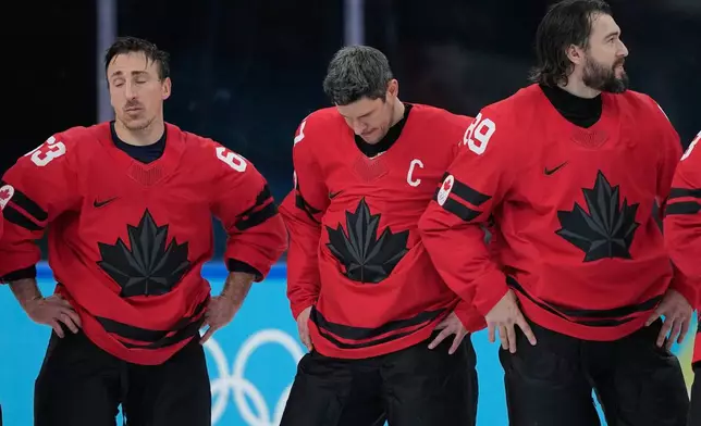 Canada's Sidney Crosby, center, reacts with teammates after losing to the United States in a men's ice hockey gold medal game between Canada and the United States at the 2026 Winter Olympics, in Milan, Italy, Sunday, Feb. 22, 2026. (AP Photo/Petr David Josek)