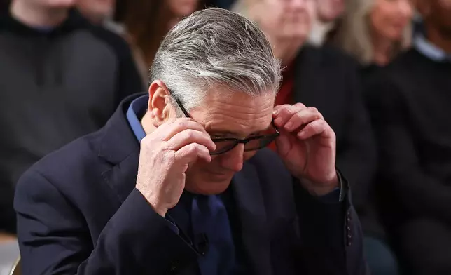 Britain's Prime Minister Keir Starmer adjusts his glasses as he waits to deliver his speech at Horntye Park Sports Complex in St Leonards-on-Sea, East Sussex, England, Thursday, Feb. 5, 2026. (Peter Nicholls/Pool Photo via AP)