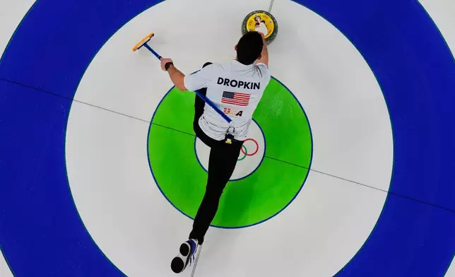 Korey Dropkin of the United States competes against Sweden during the curling mix doubles gold medal match at the 2026 Winter Olympics, in Cortina d'Ampezzo, Italy, Tuesday, Feb. 10, 2026. (AP Photo/Bernat Armangue)