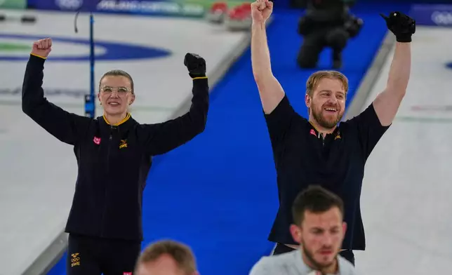 Sweden's Rasmus Wranaa and Isabella Wranaa celebrate after winning the gold medal mixed doubles curling match against USA, at the 2026 Winter Olympics, in Cortina D'Ampezzo, Italy, Tuesday, Feb. 10, 2026. (AP Photo/Misper Apawu)