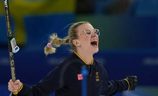 Sweden's Isabella Wranaa celebrates after winning the gold medal mixed doubles curling match against USA, at the 2026 Winter Olympics, in Cortina D'Ampezzo, Italy, Tuesday, Feb. 10, 2026. (AP Photo/Fatima Shbair)