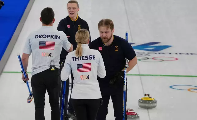 Sweden's Rasmus Wranaa and Isabella Wranaa cheer with United States' Korey Dropkin and Cory Thiesse after winning the gold medal mixed doubles curling match against USA, at the 2026 Winter Olympics, in Cortina D'Ampezzo, Italy, Tuesday, Feb. 10, 2026. (AP Photo/Misper Apawu)