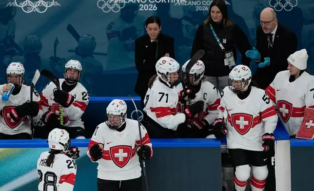 Switzerland's Laura Zimmermann, center, celebrates after scoring her side's opening goal during a preliminary round match of women's ice hockey between Switzerland and Czechia at the 2026 Winter Olympics, in Milan, Italy, Friday, Feb. 6, 2026. (AP Photo/Hassan Ammar)
