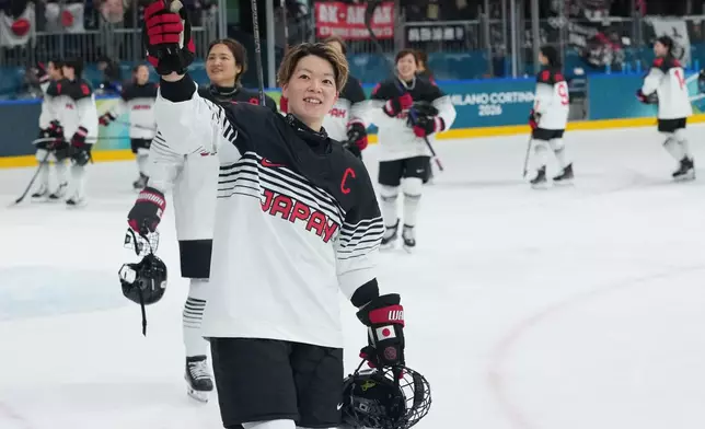 Japan's Shiori Koike and her teammates celebrate after a preliminary round match of women's ice hockey between France and Japan at the 2026 Winter Olympics, in Milan, Italy, Friday, Feb. 6, 2026. (AP Photo/Carolyn Kaster)