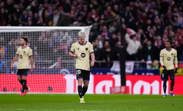 Barcelona's Dani Olmo, centre, reacts after Atletico Madrid's Antoine Griezmann scored his side's second goal during the Copa del Rey semifinal first leg soccer match between Atletico Madrid and Barcelona in Madrid, Spain, Thursday, Feb. 12, 2026. (AP Photo/Manu Fernandez)