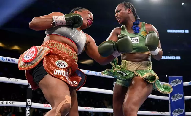 Claressa Shields, right, and Franchon Crews-Dezurn square off in the eighth round of their Undisputed Heavyweight World Championship boxing match, Sunday, Feb. 22, 2026, in Detroit. (AP Photo/Lon Horwedel)