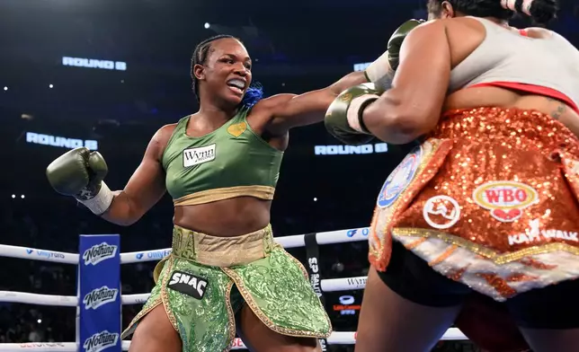 Claressa Shields, left, and Franchon Crews-Dezurn square off in the eighth round of their Undisputed Heavyweight World Championship boxing match, Sunday, Feb. 22, 2026, in Detroit. (AP Photo/Lon Horwedel)