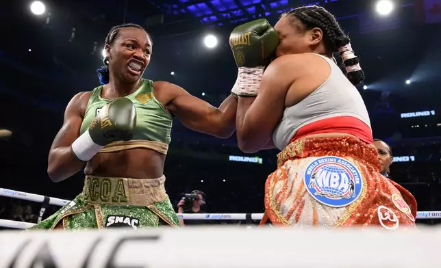 Claressa Shields, left, hits Franchon Cruz-Dezurn with a left in the first round of their Undisputed Heavyweight World Championship boxing match, Sunday, Feb. 22, 2026, in Detroit. (AP Photo/Lon Horwedel)