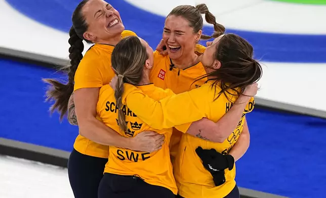 Sweden's Anna Hasselborg, Sara McManus, Sofia Scharback, Agnes Knochenhauer celebrate winning a women's curling semifinal match against Canada at the 2026 Winter Olympics, in Cortina d'Ampezzo, Italy, Friday, Feb. 20, 2026. (AP Photo/Fatima Shbair)