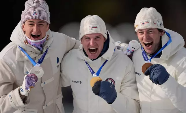 Silver medalist Eric Perrot, of France, from left, gold medalist Johan-Olav Botn, of Norway, and bronze medalist Sturla Holm Laegreid, of Norway, pose after the men's 20-kilometer individual biathlon race at the 2026 Winter Olympics in Anterselva, Italy, Tuesday, Feb. 10, 2026. (AP Photo/Mosa'ab Elshamy)