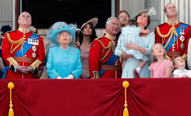 FILE - From left, Britain's Prince Andrew, Queen Elizabeth, Meghan Duchess of Sussex, Prince Charles, Prince Harry, Kate Duchess of Cambridge and Prince William attend the annual Trooping the Colour Ceremony in London, Saturday, June 9, 2018.(AP Photo/Frank Augstein, File)