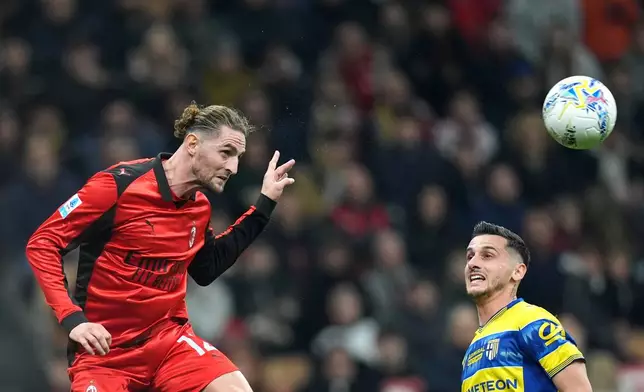 AC Milan's Adrien Rabiot, left, fights for the bass with Parma's Emanuele Valeri during the Italian Serie A soccer match between AC Milan and Parma in Milan, Italy, Sunday, Feb. 22 , 2025. (Spada/LaPresse via AP)