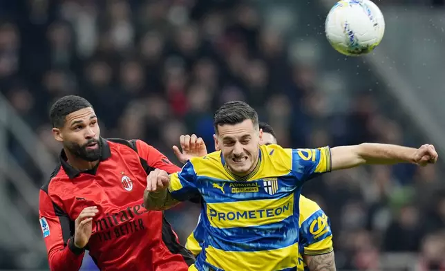 AC Milan's Ruben Loftus-Cheek, left, fights for the bass with Parma's Emanuele Valeri during the Italian Serie A soccer match between AC Milan and Parma in Milan, Italy, Sunday, Feb. 22 , 2025. (Spada/LaPresse via AP)