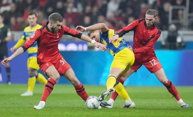 Parma's Mateo Pellegrino is challenged by AC Milan's Strahinja Pavlovic and Adrien Rabiot during the Italian Serie A soccer match between AC Milan and Parma in Milan, Italy, Sunday, Feb. 22 , 2025. (Spada/LaPresse via AP)
