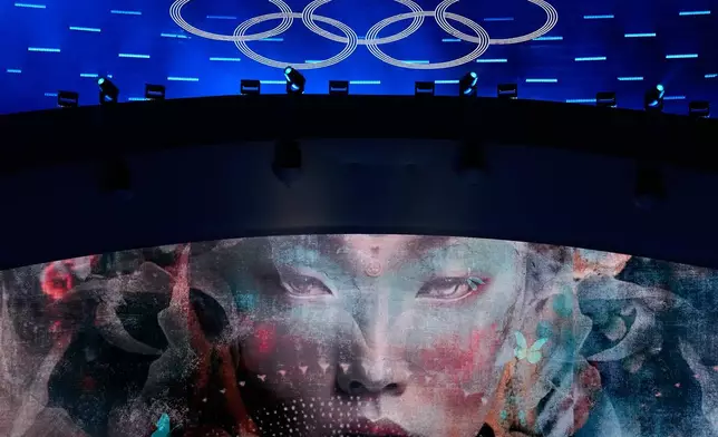 The Olympic rings are illuminated during a performance at the closing ceremony of the 2026 Winter Olympics, in Verona, Italy, Sunday, Feb. 22, 2026. (AP Photo/Natacha Pisarenko)