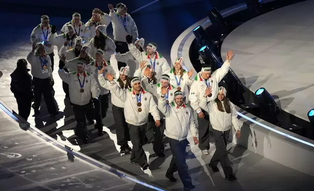 Italian medallists arrive for the closing ceremony of the 2026 Winter Olympics, in Verona, Italy, Sunday, Feb. 22, 2026. (AP Photo/Antonio Calanni)