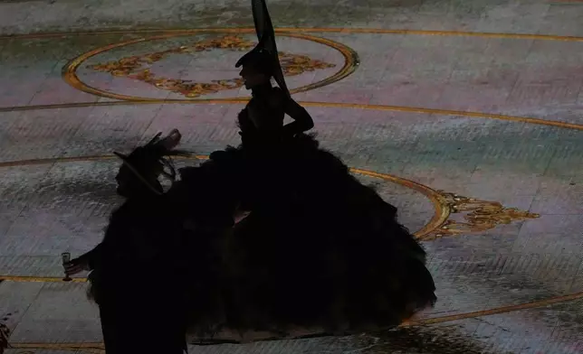 Artists are silhouetted as they perform during the closing ceremony of the 2026 Winter Olympics, in Verona, Italy, Sunday, Feb. 22, 2026. (AP Photo/Antonio Calanni)