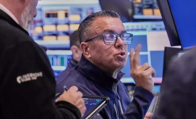 Trader Robert FInnerty Jr. works on the floor of the New York Stock Exchange, Thursday, Feb. 5, 2026. (AP Photo/Richard Drew)