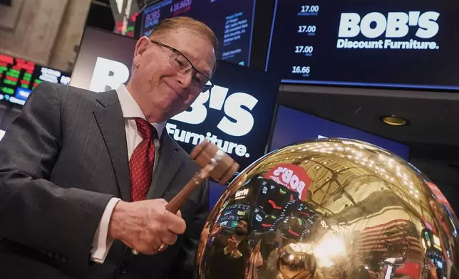 Bob's Discount Furniture President &amp; CEO Bill Barton rings a ceremonial bell on the floor of the New York Stock Exchange as his company's IPO begins trading, Thursday, Feb. 5, 2026. (AP Photo/Richard Drew)