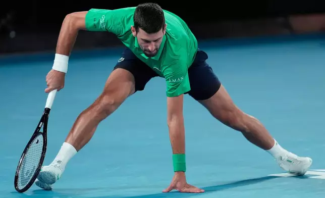Novak Djokovic of Serbia braces himself after playing a shot to Carlos Alcaraz of Spain during the men's singles final at the Australian Open tennis championship in Melbourne, Australia, Sunday, Feb. 1, 2026. (AP Photo/Asanka Brendon Ratnayake)